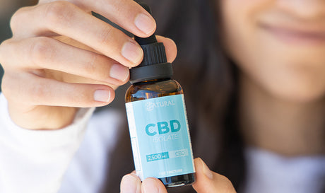 Women holding CBD isolate oil in hand. What is CBD isolate