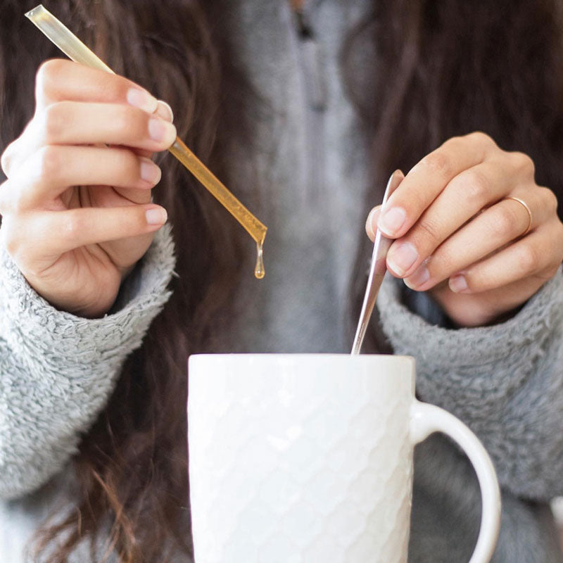 Zatural CBD Honey Sticks in a cup