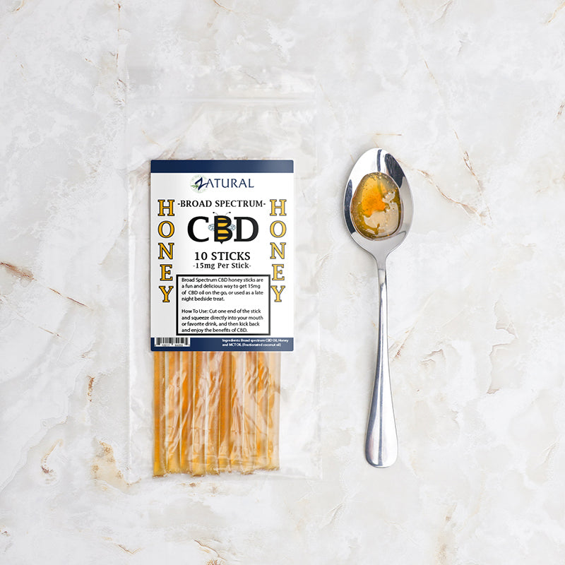 Zatural Honey Sticks with honey in spoon