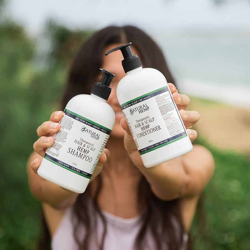 Zatural Hemp Shampoo and Condition being held by a women.