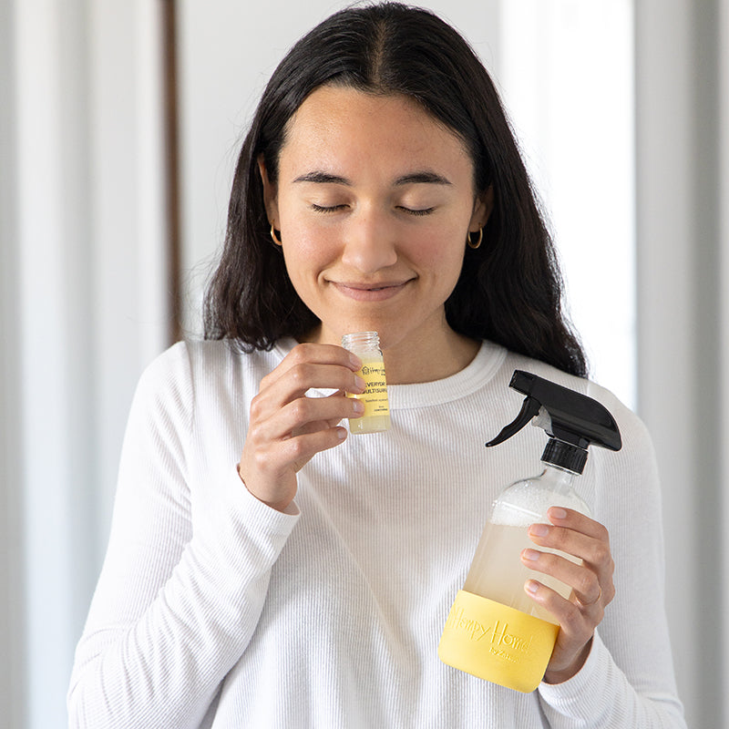 Hempy Home Everyday and multisurface concentrate cleaner and spray bottle in a women's hand