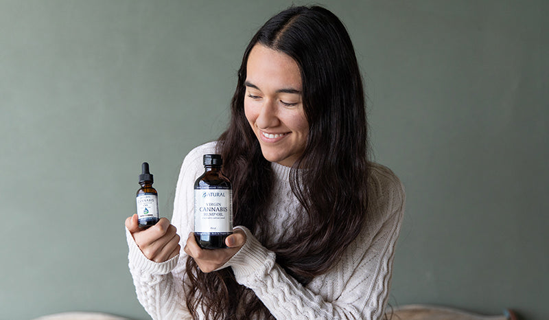 Man sitting on a road with his laptop. Is cbd or hemp oil better for anxiety? hemp oil vs cbd oil for anxiety. hemp extract vs cbd oil. 
