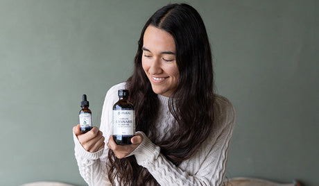 Man sitting on a road with his laptop. Is cbd or hemp oil better for anxiety? hemp oil vs cbd oil for anxiety. hemp extract vs cbd oil. 
