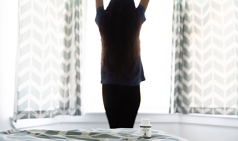 women stretching after waking up from sleep. Does hemp oil help you sleep 