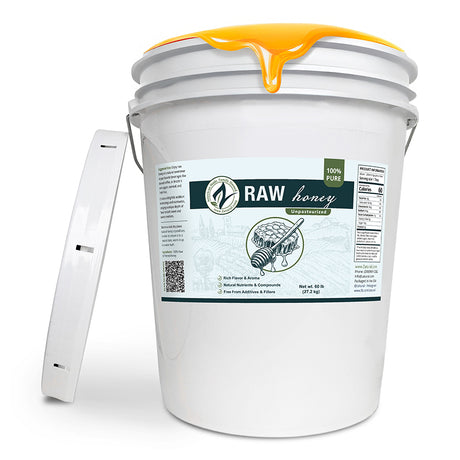 White bucket of raw honey with a label on a white background