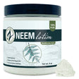 Neem lotion jar with a small amount of lotion on a white background