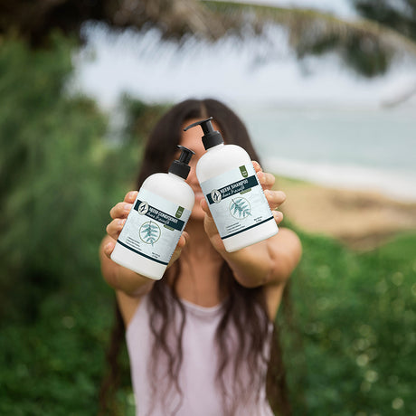 Person holding two bottles of New Formulas skincare products outdoors with a blurred natural background