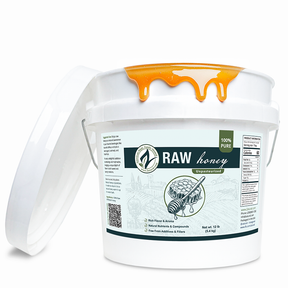 White container of raw honey with a label on a white background