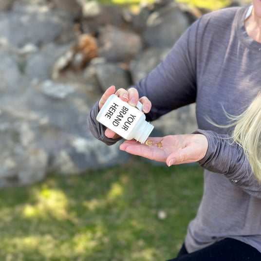 Women taking Softgels with white labeling options