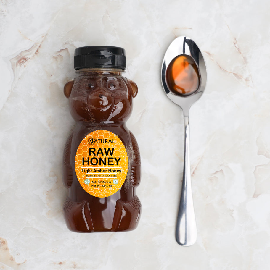 Zatural Raw Honey with honey on a spoon